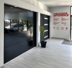 High-gloss black contemporary garage door and modern panel styles at the Burlington showroom.