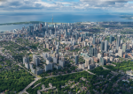 High-altitude aerial view of downtown Toronto skyline and Lake Ontario.