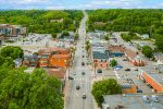 Aerial bird's-eye view of downtown Bolton Ontario showing Queen Street and surrounding green hills.