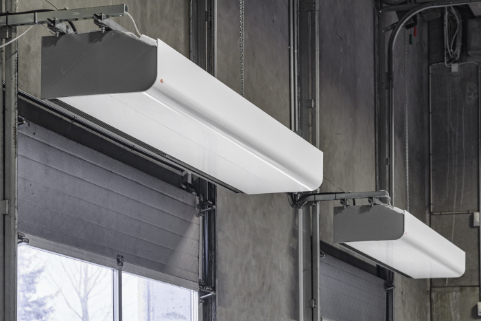 Heavy-duty commercial air curtains mounted above warehouse loading dock doors for energy efficiency and temperature retention.