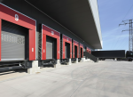 Professional installation of commercial dock shelters and red sectional doors by the Dodds Garage Doors expert team at a Southern Ontario logistics hub.