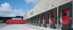 Industrial loading dock shelters installed at a commercial warehouse facility by Dodds Garage Doors, featuring red dock doors and weather-resistant seals for improved operational efficiency in Southern Ontario.