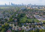 A green park in a Cooksville residential area with the Mississauga city center skyline in the background.