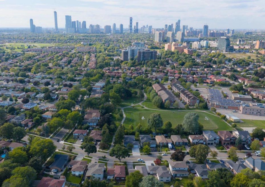 A green park in a Cooksville residential area with the Mississauga city center skyline in the background.