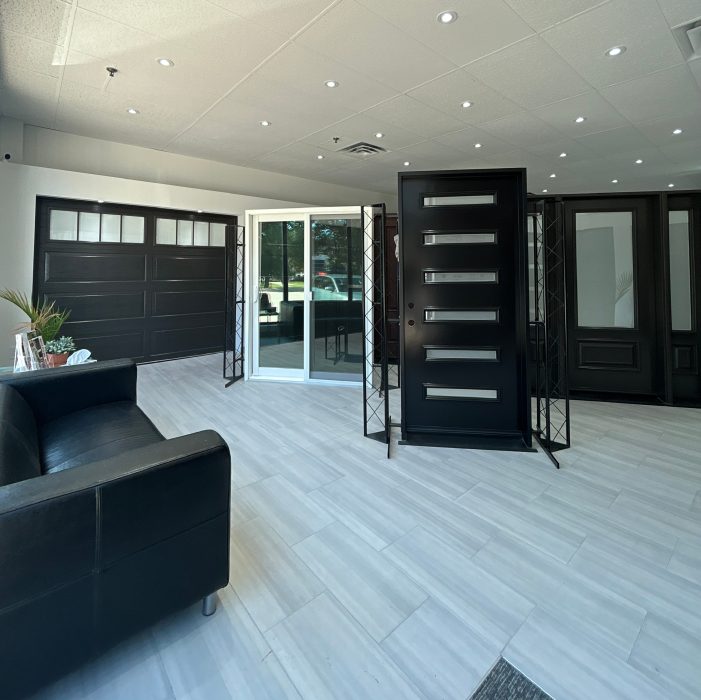 Modern black garage door and contemporary front entry door on display at the Dodds showroom.