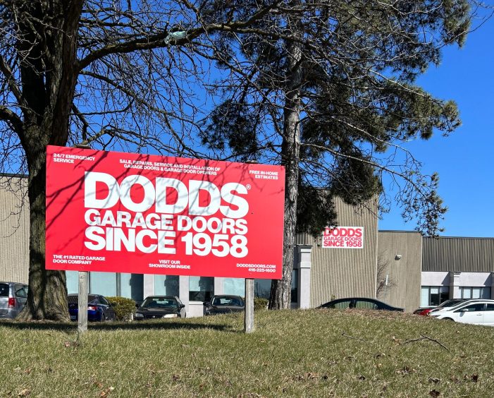 Dodds Garage Doors North York location signage offering 24/7 emergency repair and new installations.