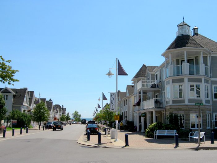 Street level view of Pickering waterfront homes featuring premium garage door designs.
