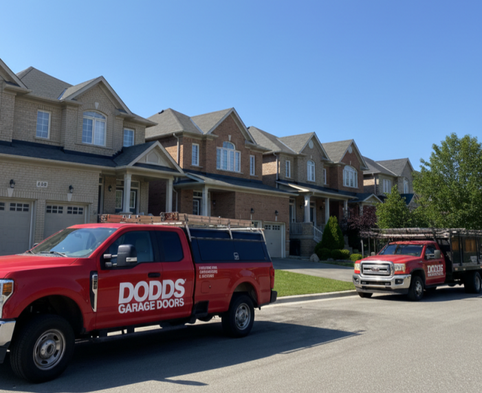 Red Dodds Garage Doors service trucks parked on a residential street in Oshawa ready for repair work.
