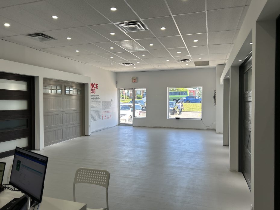 Modern flush contemporary black garage door featuring long vertical frosted glass windows at the Whitby showroom.