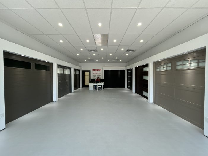 Full interior wide-angle shot of the modern Dodds Garage Doors selection center showroom in Whitby.