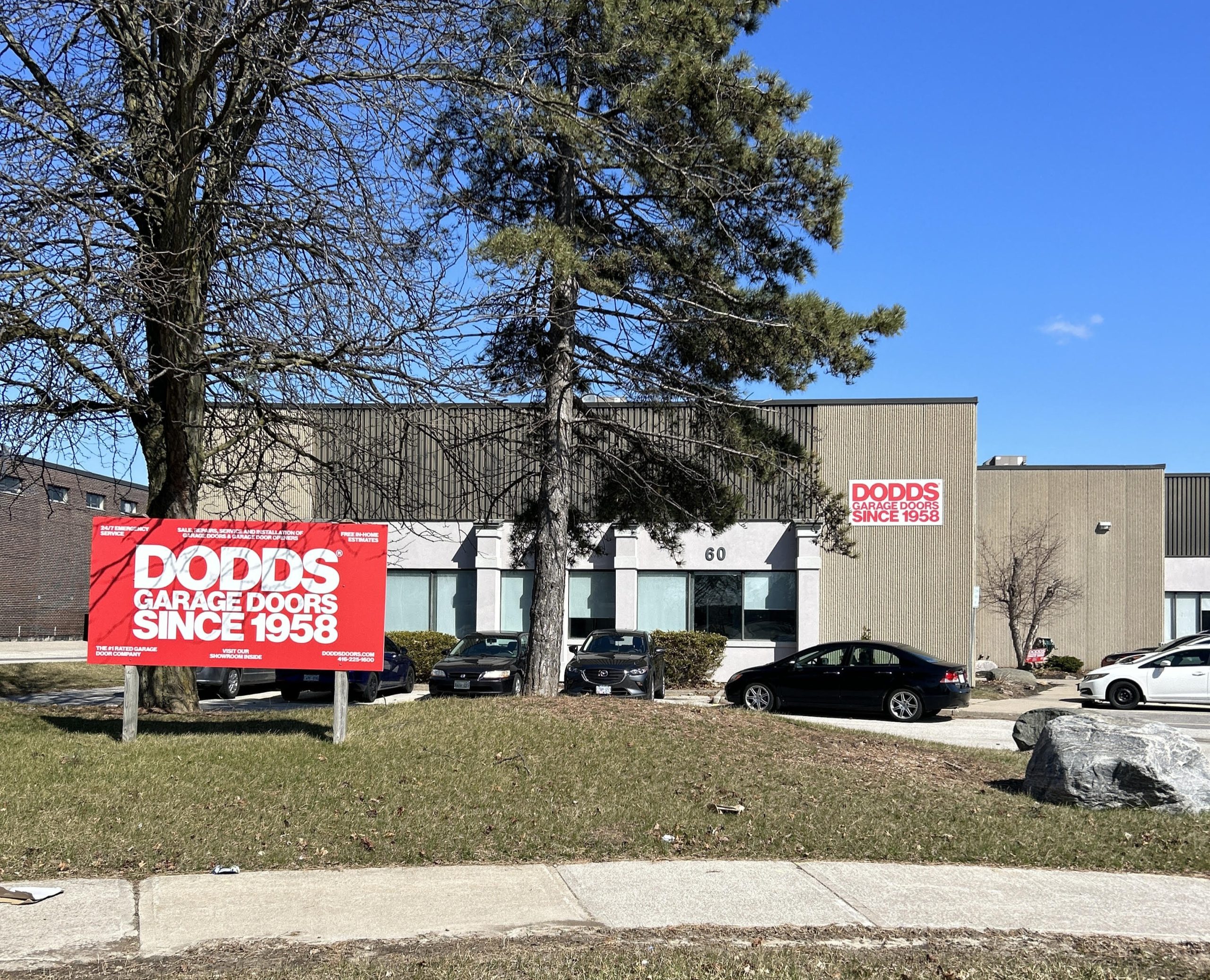 The exterior of the Dodds Garage Doors showroom and warehouse in Toronto with branded signage.