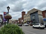 A busy street in downtown Aurora, Ontario, showing the local community served by professional garage door installers.