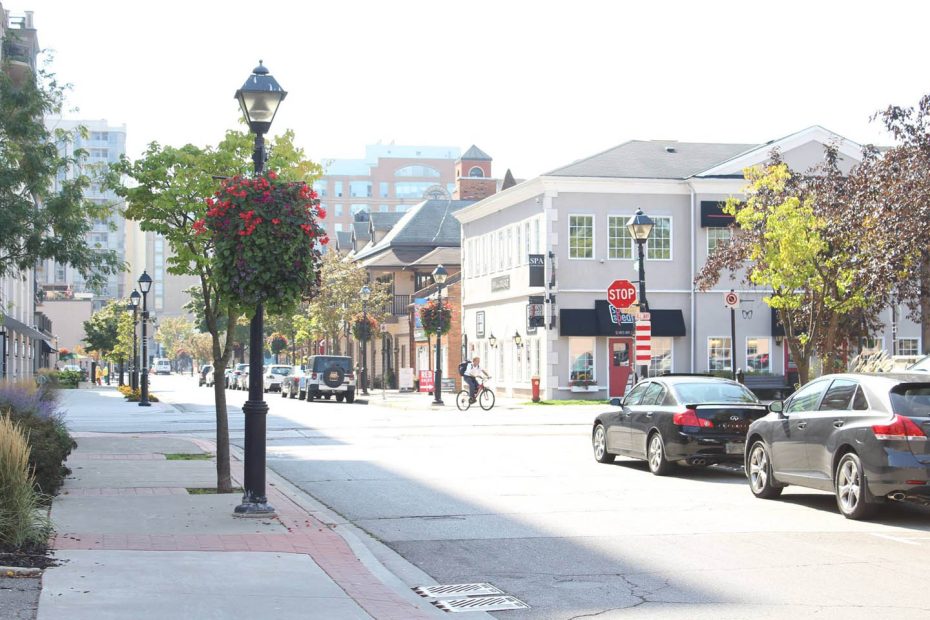 Vibrant downtown Burlington, Ontario streetscape featuring local shops and boutiques near Village Square.