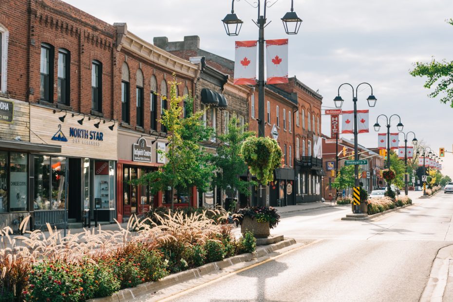 Historic downtown Georgetown Ontario street view with Canadian flags and local shops.