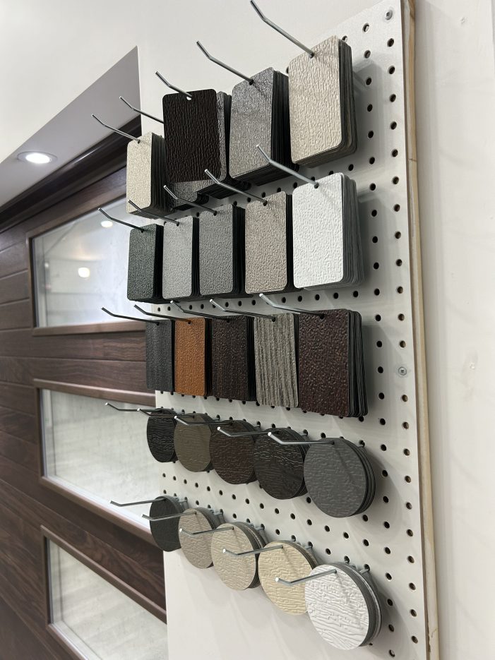 A display showcasing various color swatches and texture samples for dodds garage door finishes.