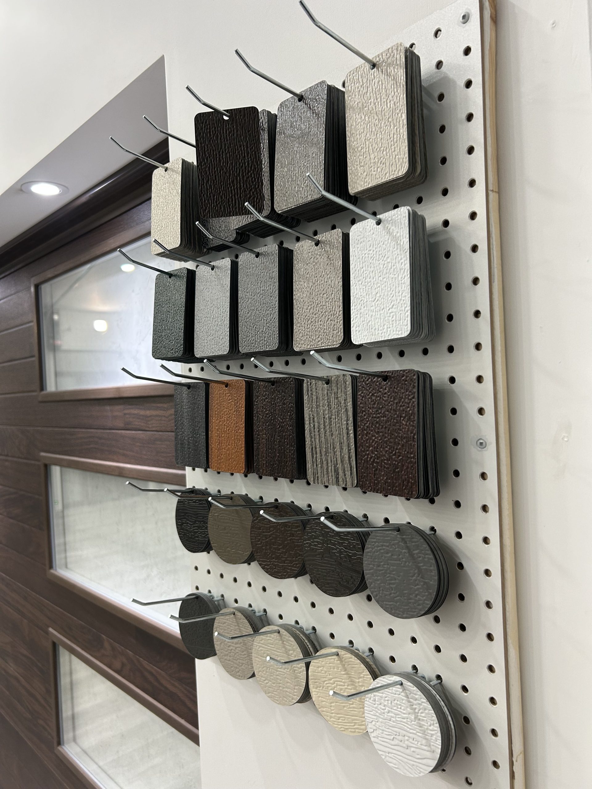 A display showcasing various color swatches and texture samples for dodds garage door finishes.