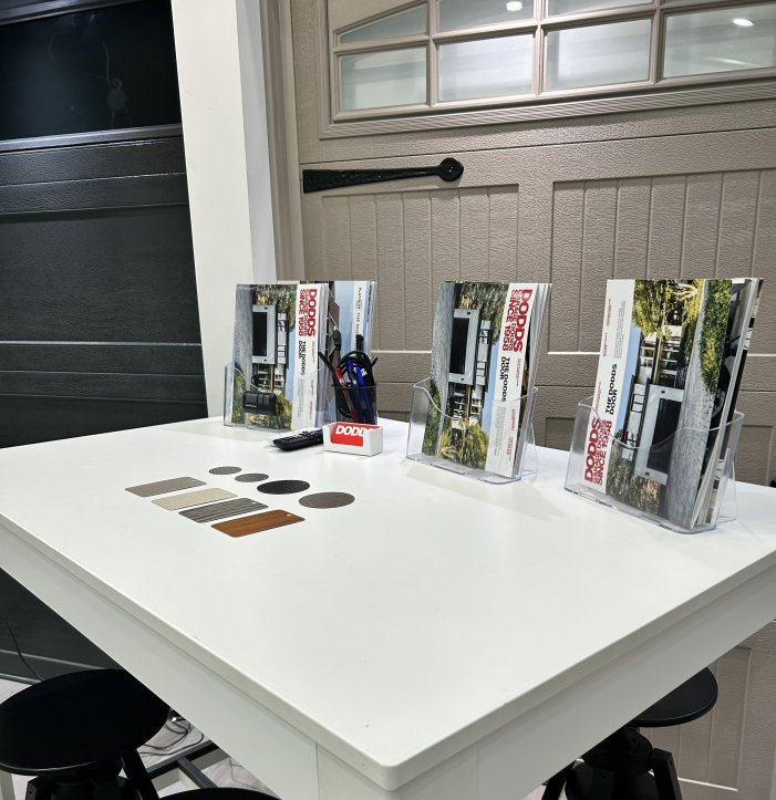 Garage door material samples and brochures at a design consultation center serving Concord and Vaughan homeowners.