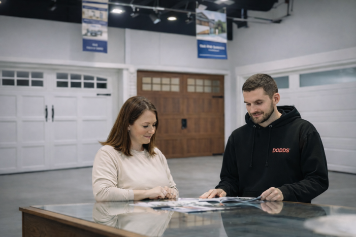Customers browsing traditional and carriage-style garage doors at a local Bolton Ontario showroom with an expert consultant.