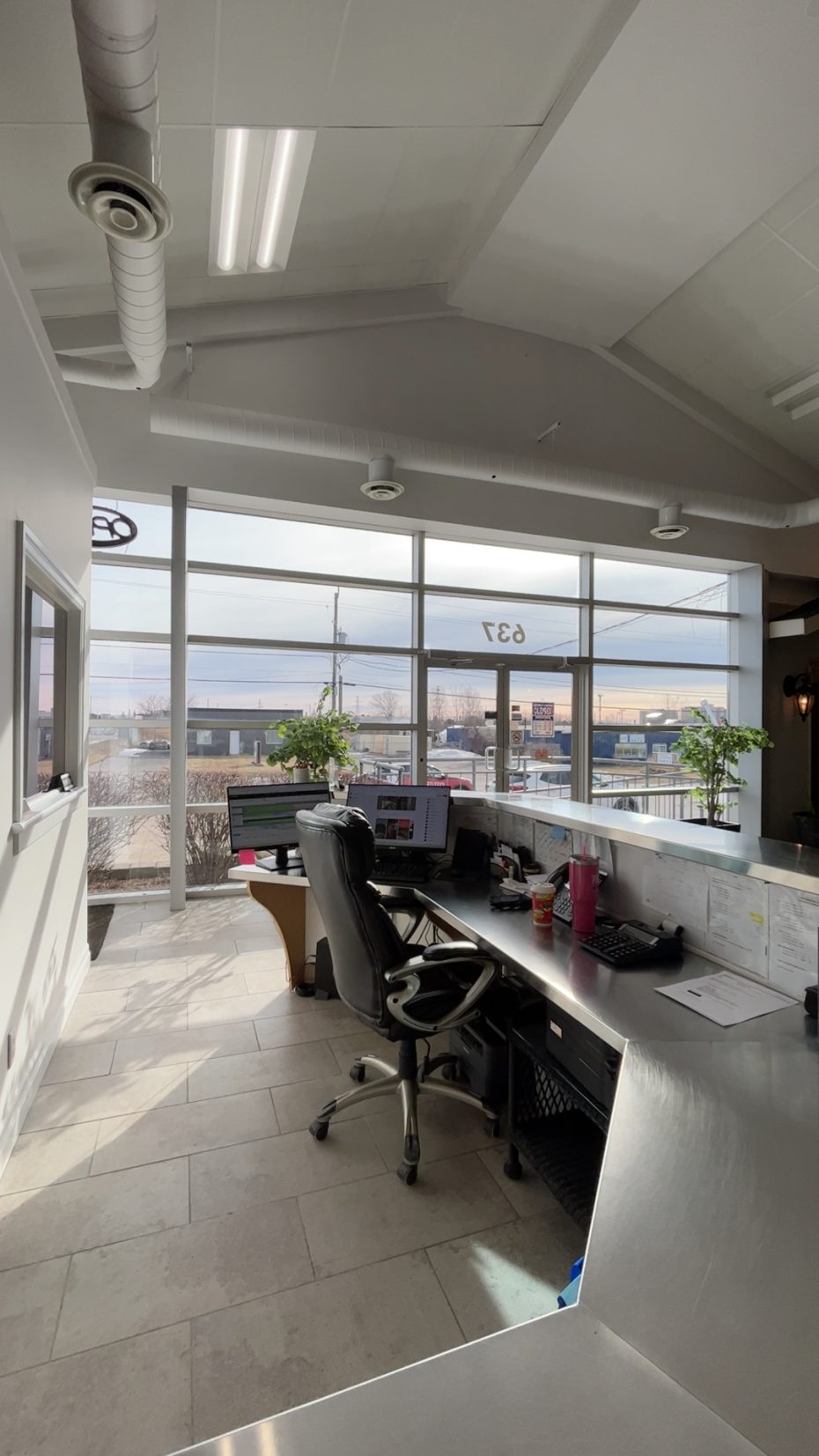 Interior view of the Kingston garage door showroom reception and customer service area with large bright windows.