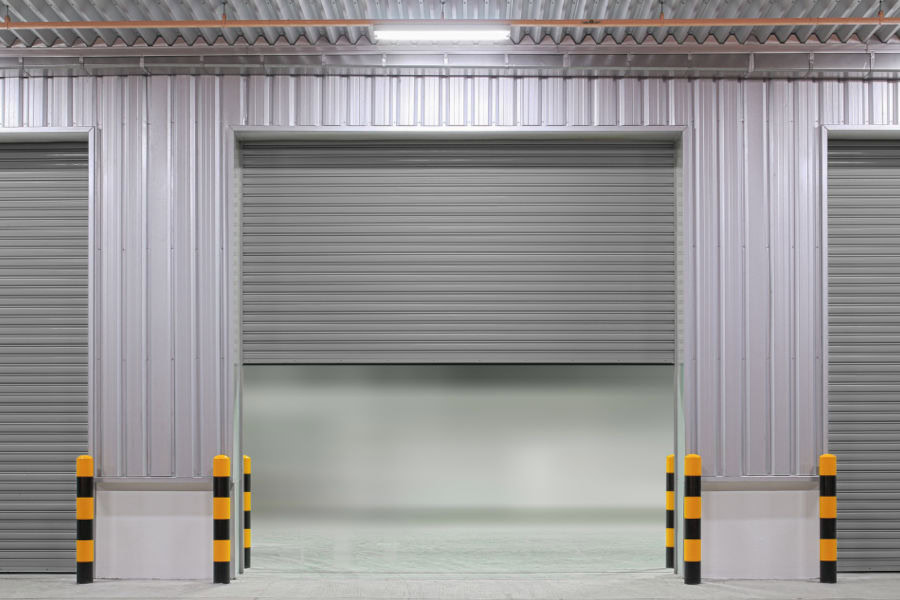 Heavy-duty industrial rolling fire door providing essential compartmentalization and security for large-scale warehouses in Southern Ontario.
