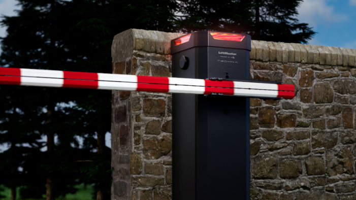 LiftMaster automatic commercial barrier gate arm with red LED safety lighting installed at a secure property entrance.