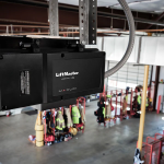 Overhead installation of a heavy-duty commercial trolley garage door opener for high-cycle industrial use.