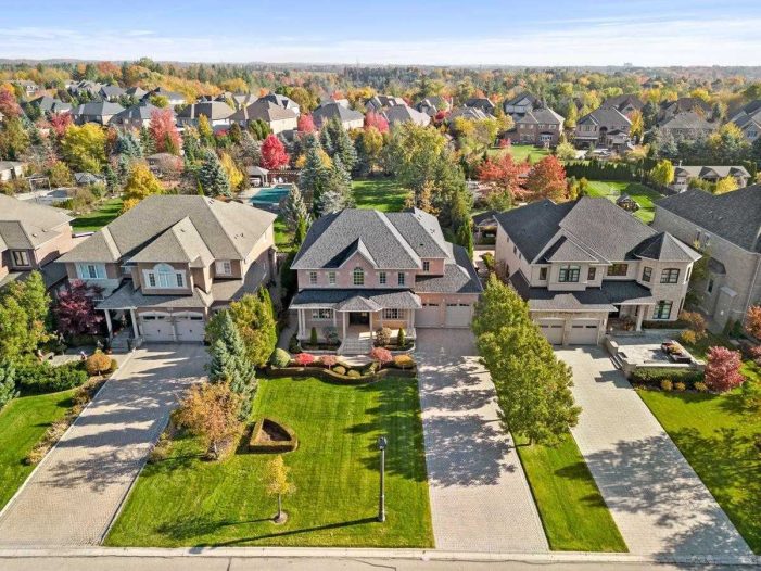 Upscale residential street in Vaughan showing homes with modern garage doors installed by Dodds Garage Doors.