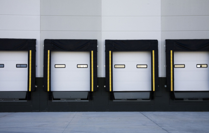 Industrial hydraulic dock leveler conversion kit used to upgrade manual mechanical docks to push-button hydraulic operation for improved safety and efficiency in Ontario warehouses.