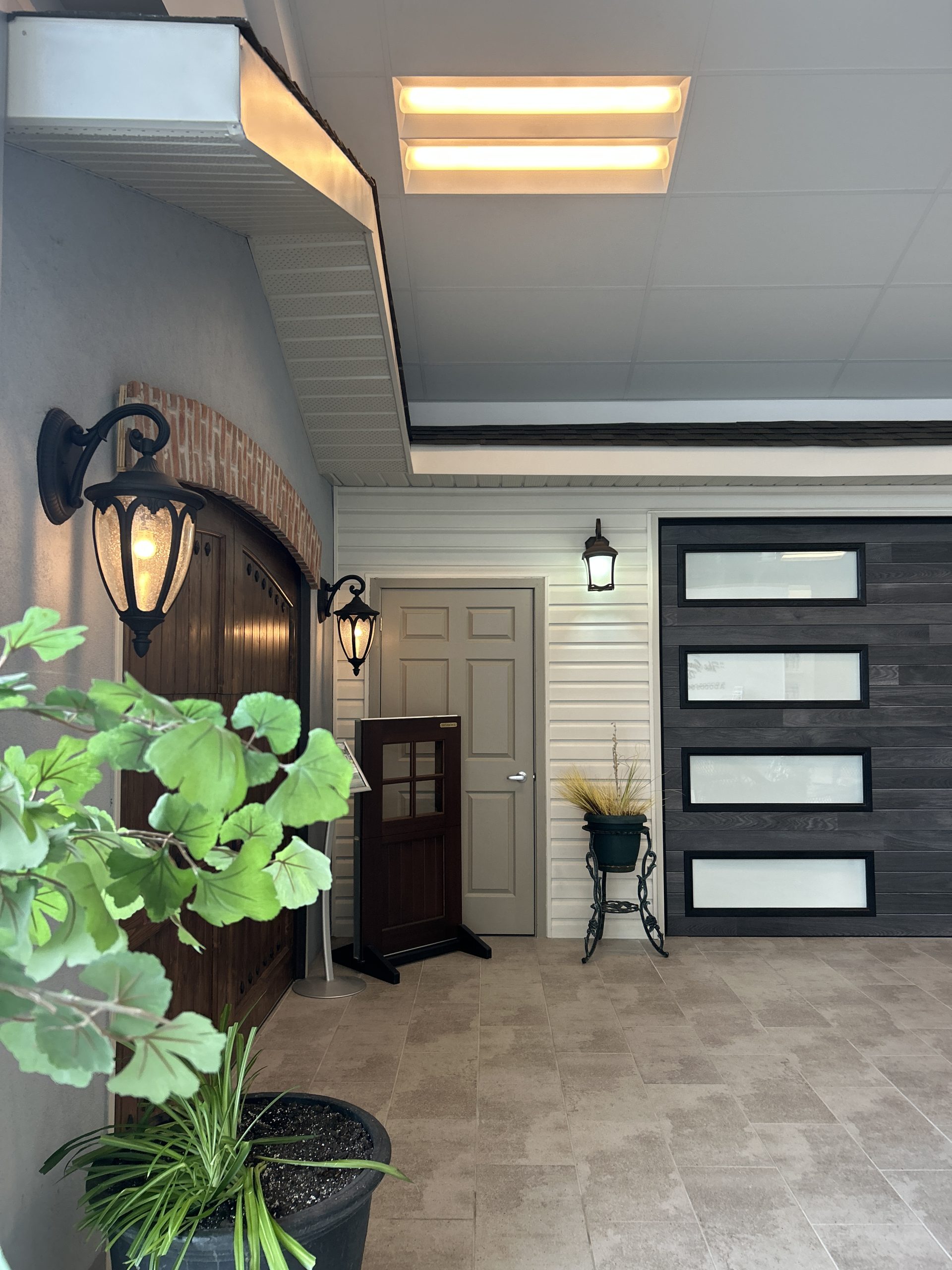 Contemporary black garage door with frosted glass horizontal windows on display at Dodds Doors in Kingston.