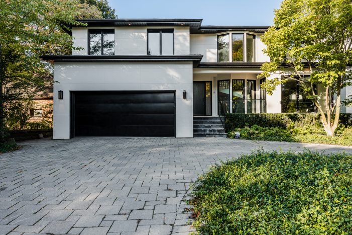 Modern black flush panel garage door installed on a luxury contemporary home in North York.
