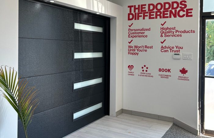 Interior of the Dodds Garage Doors showroom featuring a modern black door and customer service guarantees.