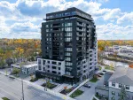 A modern multi-story residential condominium building in Georgetown, Ontario, showcasing contemporary urban architecture and glass balconies.