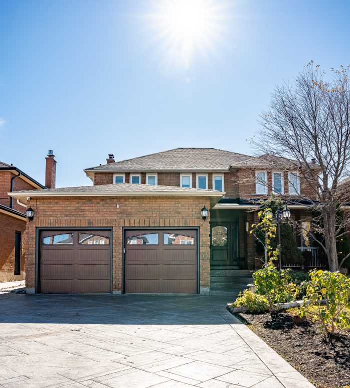 New double car garage door installation on a brick residential home in Cooksville, Mississauga.