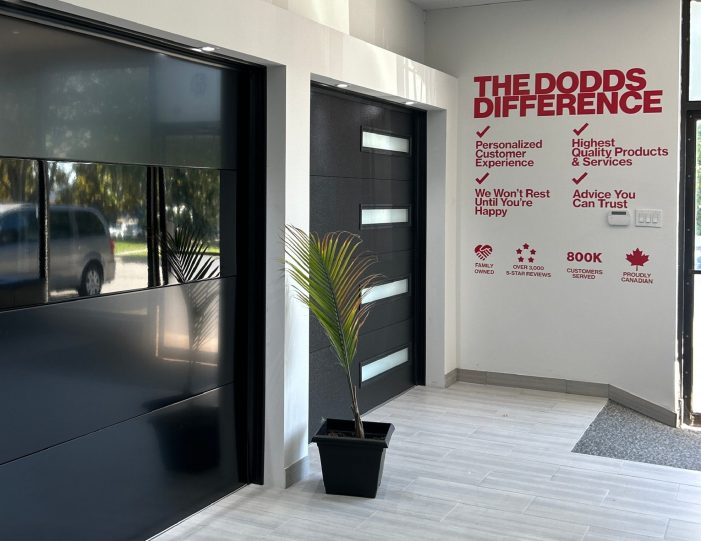 Interior view of the Dodds Garage Doors showroom featuring modern black glass and contemporary panel garage door displays.