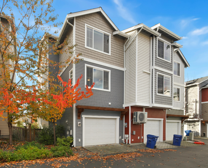 Multi-story modern townhouses in Bolton Ontario featuring clean white sectional garage doors.