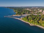 Aerial view of the Oakville harbor, lighthouse, and marina on a clear day.