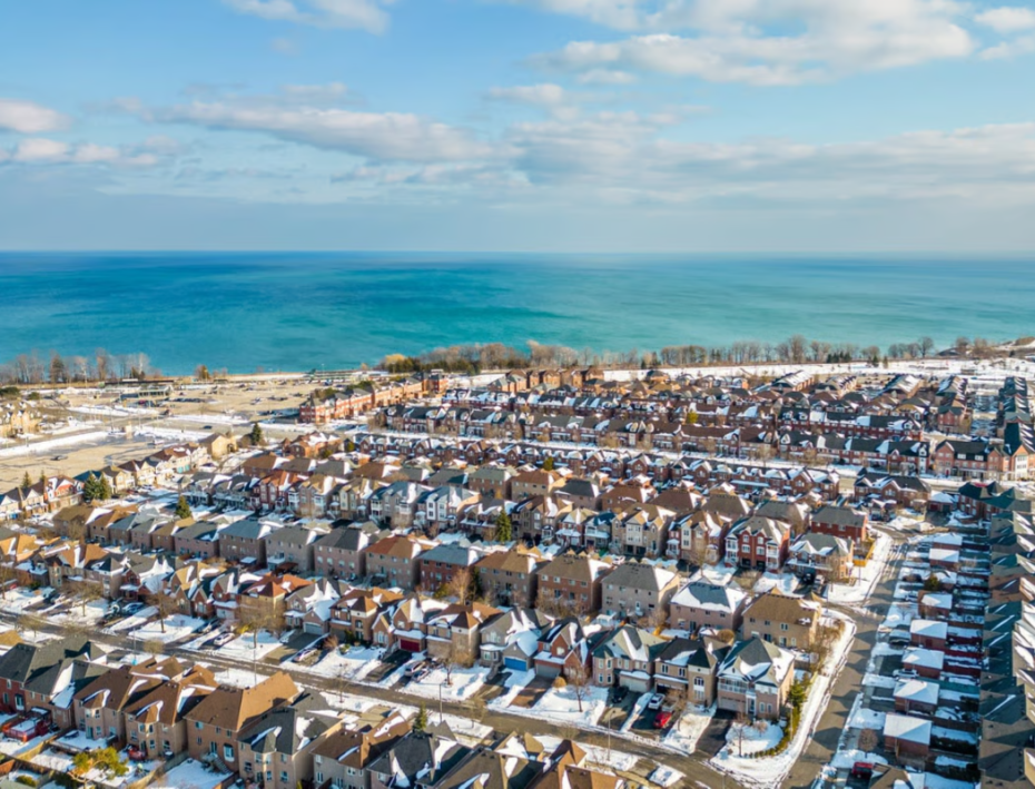Winter view of a Pickering residential subdivision showcasing various garage door styles and installations.