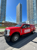 Side view of a red Dodds Garage Doors service vehicle in Vaughan, specialized in professional garage door installation and maintenance.