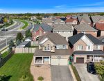 Modern suburban homes with double-car garage doors in a Bolton Ontario residential community.