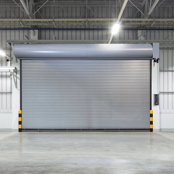 Dodds Garage Doors service van at a commercial site featuring a durable rolling steel door installation for a Southern Ontario business.
