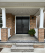 High-security double steel entry doors in a dark brown finish with arched panels, installed on a brick home in the GTA.