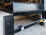 A row of multiple hydraulic dock levelers integrated into a distribution center floor to improve shipping and receiving efficiency.