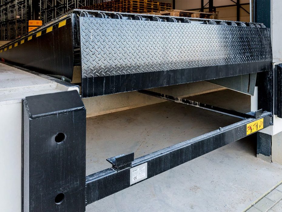 A row of multiple hydraulic dock levelers integrated into a distribution center floor to improve shipping and receiving efficiency.