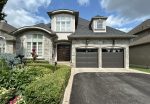 Front view of a two-car garage with Dodds Canadian Series insulated garage doors in Cafe finish installed in Richmond Hill.