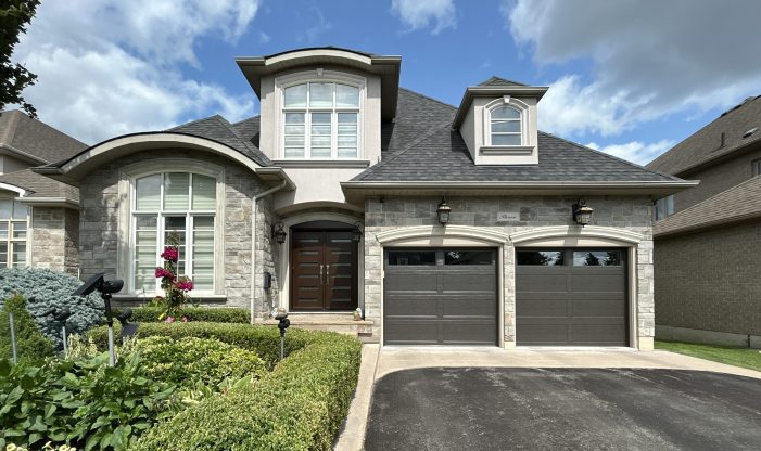 Front view of a two-car garage with Dodds Canadian Series insulated garage doors in Cafe finish installed in Richmond Hill.