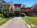 Crisp angle view of a flush modern garage door installed under a wood-accented overhang in Toronto.