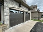 Angled detail view of a Dodds Cafe recessed panel garage door installation showing quiet operation tracks and dark brown trim.