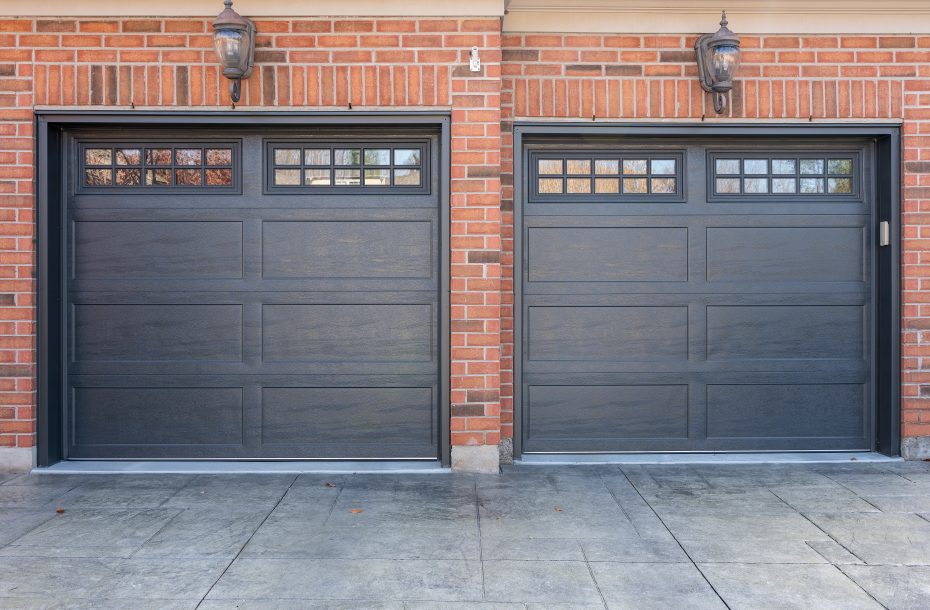 Close-up of a double iron ore long panel recessed garage door installation by Dodds on a brick home.