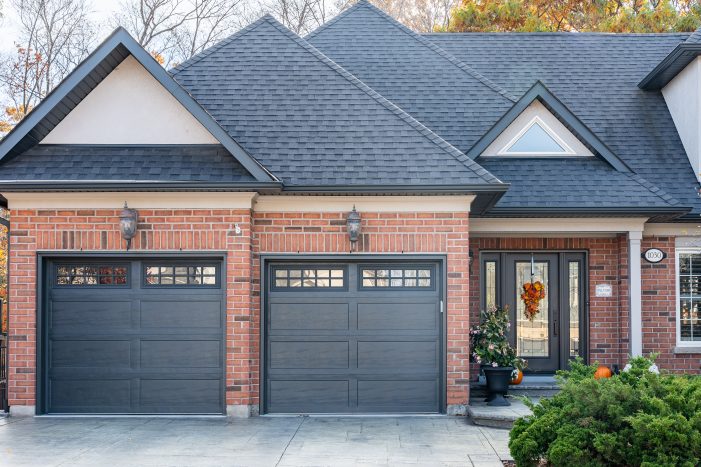 Front entry and garage area showing a high-quality iron ore recessed long panel garage door installation by Dodds.