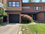 Sleek black flush garage door replacement highlighting the clean lines and matching aluminum capping.